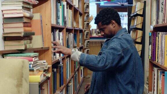 在二手书店扫描书架的书籍爱好者