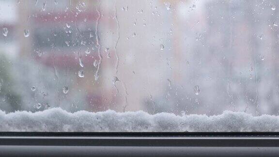磨砂窗与雪外面的背景寒冷潮湿的天气在窗玻璃上