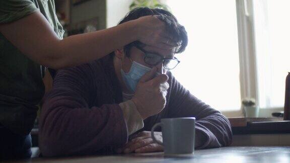 妇女照顾她生病的丈夫戴着防护口罩和咳嗽