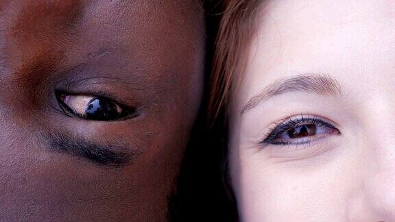 一名黑人男子和一名白人女子闭着眼睛看着摄像机