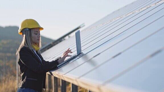在太阳能发电厂工作的女工程师可再生能源系统太阳能城市