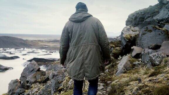一名年轻的旅游男子徒步穿越冰岛Vatnajokull冰泻湖的山脉