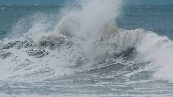 暴风雨的波在大西洋的强风暴中带着泡沫和泥土的巨浪拍打着海岸