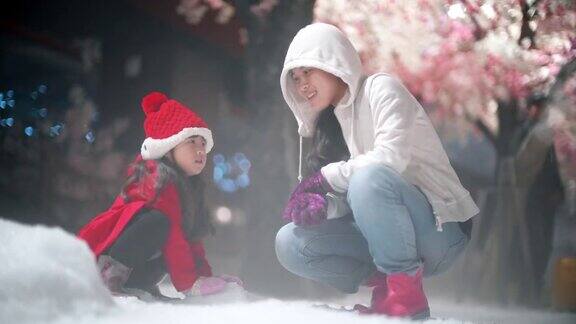 小女孩玩雪与樱花树的背景