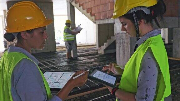 工程师和一名企业家在工地上用平板电脑检查工作进度