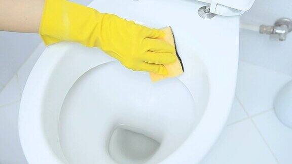 手戴黄色手套清洁厕所