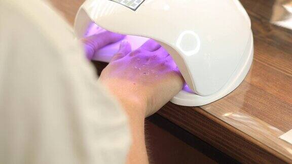 虫胶美甲在紫外线灯下干燥凝胶指甲油的过程