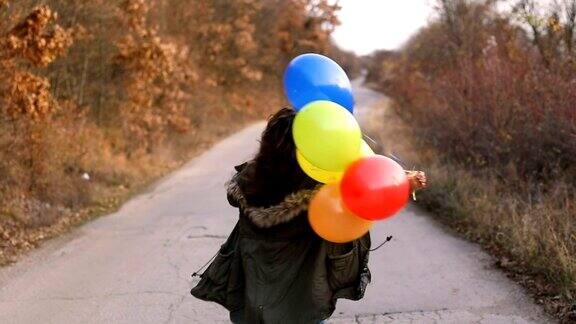 快乐的年轻女子与彩色气球
