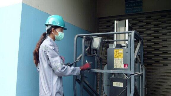 亚洲女技术员检查机器的电力安全女性措施公众的