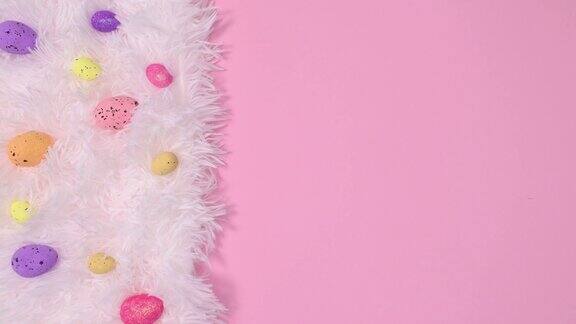 复活节彩蛋的粉彩出现在亮粉色的背景上的白色毛皮上停止运动