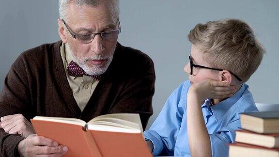 老人给孙子读书辅导家庭作业共度时光