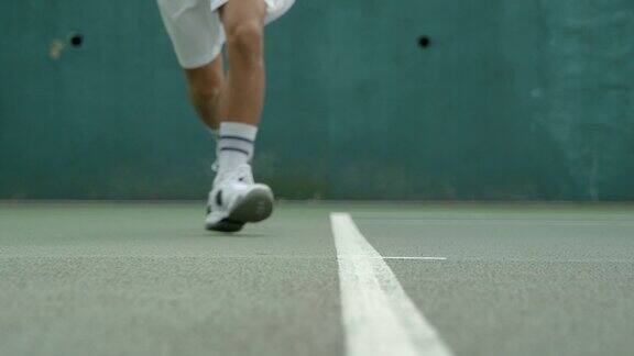 一名网球运动员在底线外击球慢镜头
