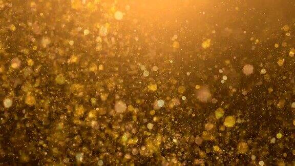 闪闪发光的金色火花在模糊的背景中飞舞