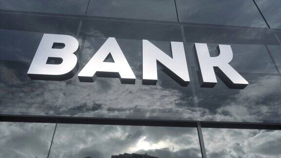 玻璃建筑上的银行标志现代立面上的镜像天空和城市商业和财务概念