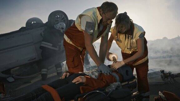 车祸现场:医护人员抢救躺在担架上的女性受害者的生命他们敷上氧气面罩做心肺复苏和急救