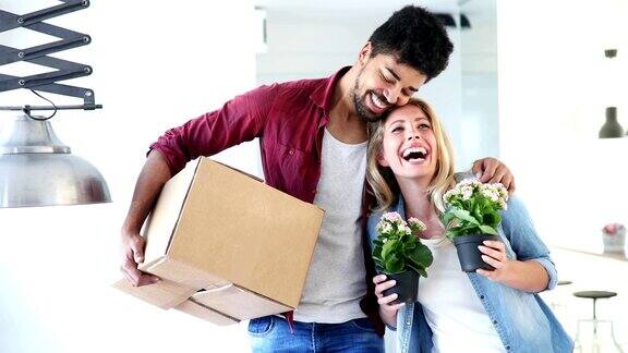 年轻幸福的夫妇搬进新家打开箱子
