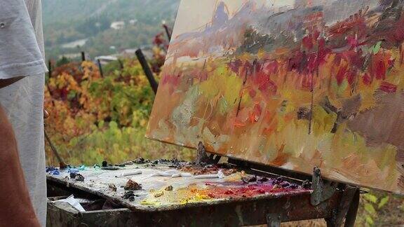 艺术家画一幅画秋天的葡萄园