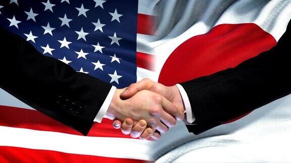 美国和日本握手国际友谊旗帜背景