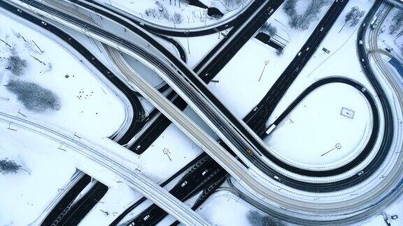 航拍鸟瞰冬天被雪覆盖的高速公路交叉口