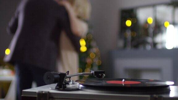 一对不认识的夫妇在家里随着黑胶唱片慢慢跳舞