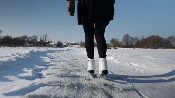 冬天在湖上滑冰在冰上穿着白色花样滑冰鞋的女性脚冬天女人在结了冰的池塘上滑冰冬天的活动