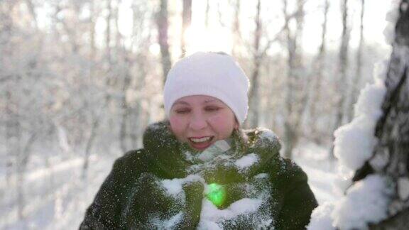 女孩在冬天的树林里散步抛雪微笑大笑在新鲜空气中散步