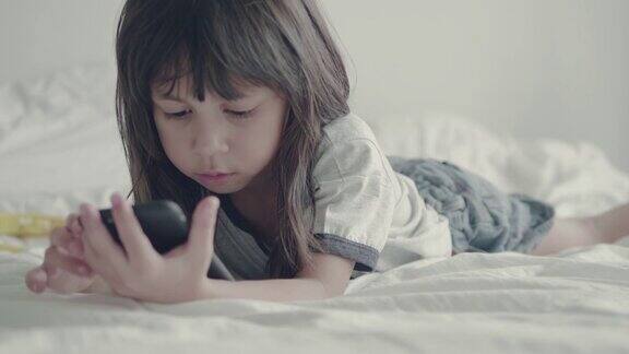 小女孩在家里玩和触摸手机