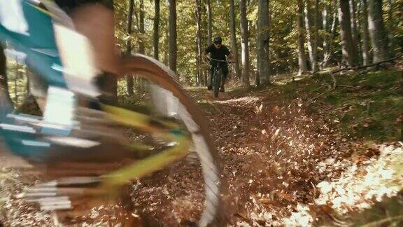 SLOMO山下山地自行车手在森林中穿越弯道