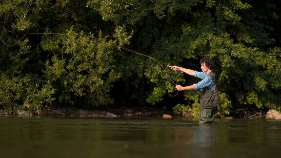 在森林河中钓鱼的渔夫