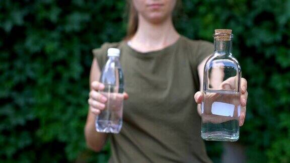 负责任的女士选择可重复使用的玻璃瓶而不是塑料瓶拯救地球
