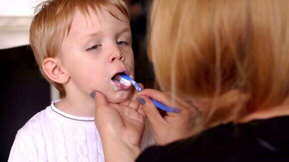 妈妈在帮儿子刷牙