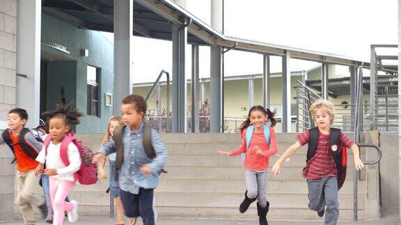 年轻的学生在离开学校时跳下台阶