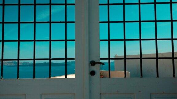 缓慢倾斜的拍摄一个典型的基克拉迪地中海门与海景