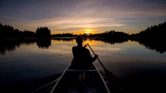 在日落中划独木舟