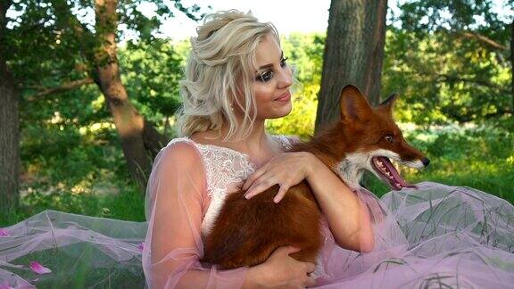 肖像美丽的女人手里拿着红狐狸和微笑