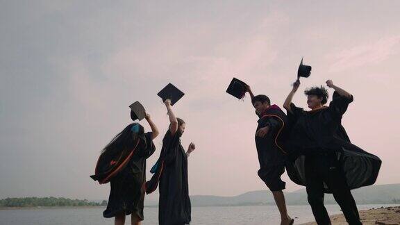 学生们在蓝天中抛掷毕业帽在空中庆祝