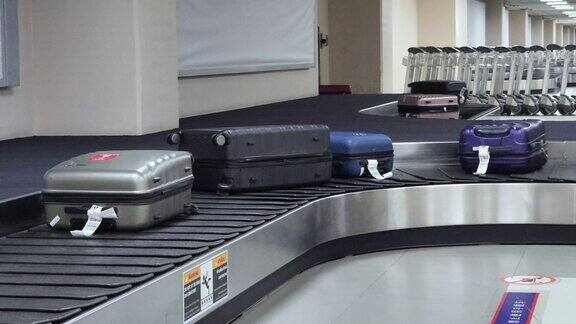在机场行李提取区的传送带上移动的热门旅行包