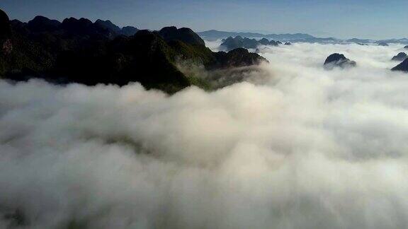 飞行摄像机在山顶上的白云上移动