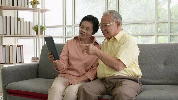 一对老年夫妇在家里使用平板电脑