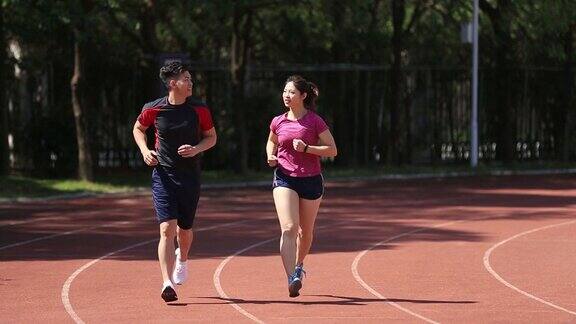亚洲夫妇在体育场慢跑