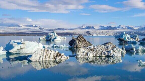 4k时间移动的云与蓝色冰山漂浮在Jokulsarlon冰湖冰岛