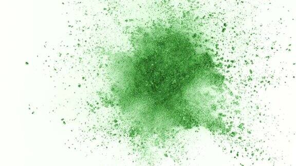 绿色粉末在白色背景上以超慢镜头爆炸