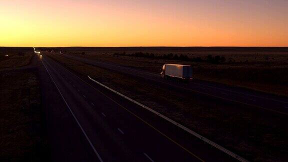 航拍黎明时在高速上行驶的货车