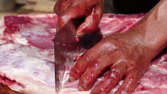 农民用带血的手切猪肉