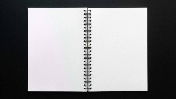 4k停止运动的笔记本打开空白页在黑色背景
