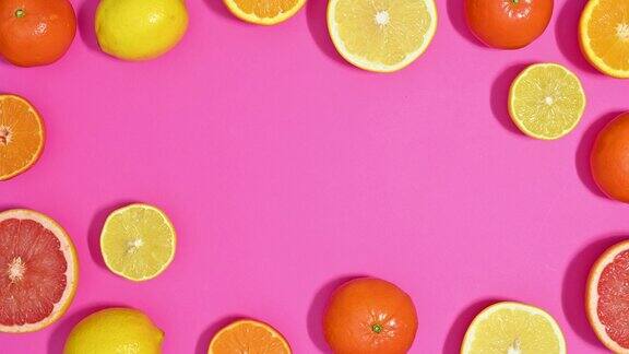 新鲜成熟切片柑橘水果使框架边界充满活力的粉红色主题止动平铺