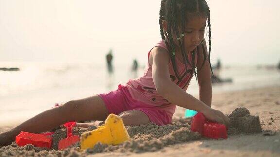 一个女孩在海滩上建造沙堡