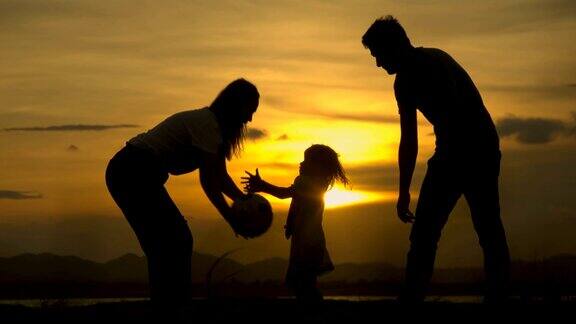 快乐的亚洲家庭爸爸妈妈和女儿在海滩上玩日落高清慢镜头