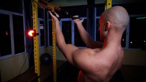 肌肉强壮出汗的男子二头肌和胸部训练与阻力带