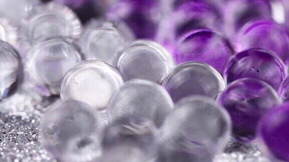 在紫色和银色表面旋转的水凝胶球关闭宏